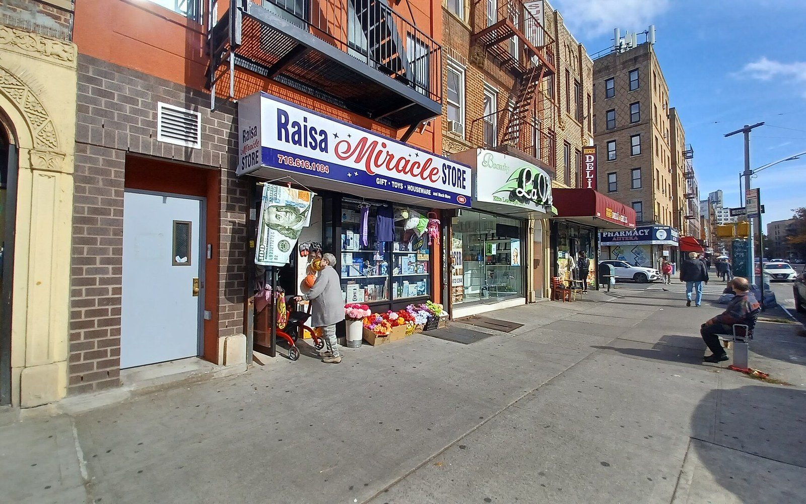 A Brighton Beach Avenue shopfront with Russian signage and a shopper at the door